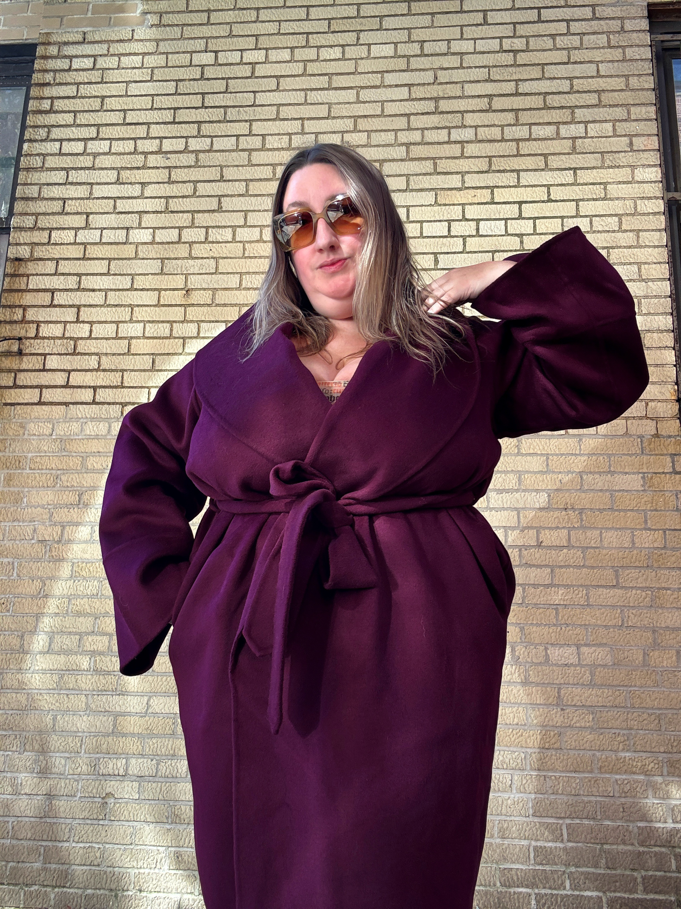 Sarah Chiwaya wearing a bold color wrap coat