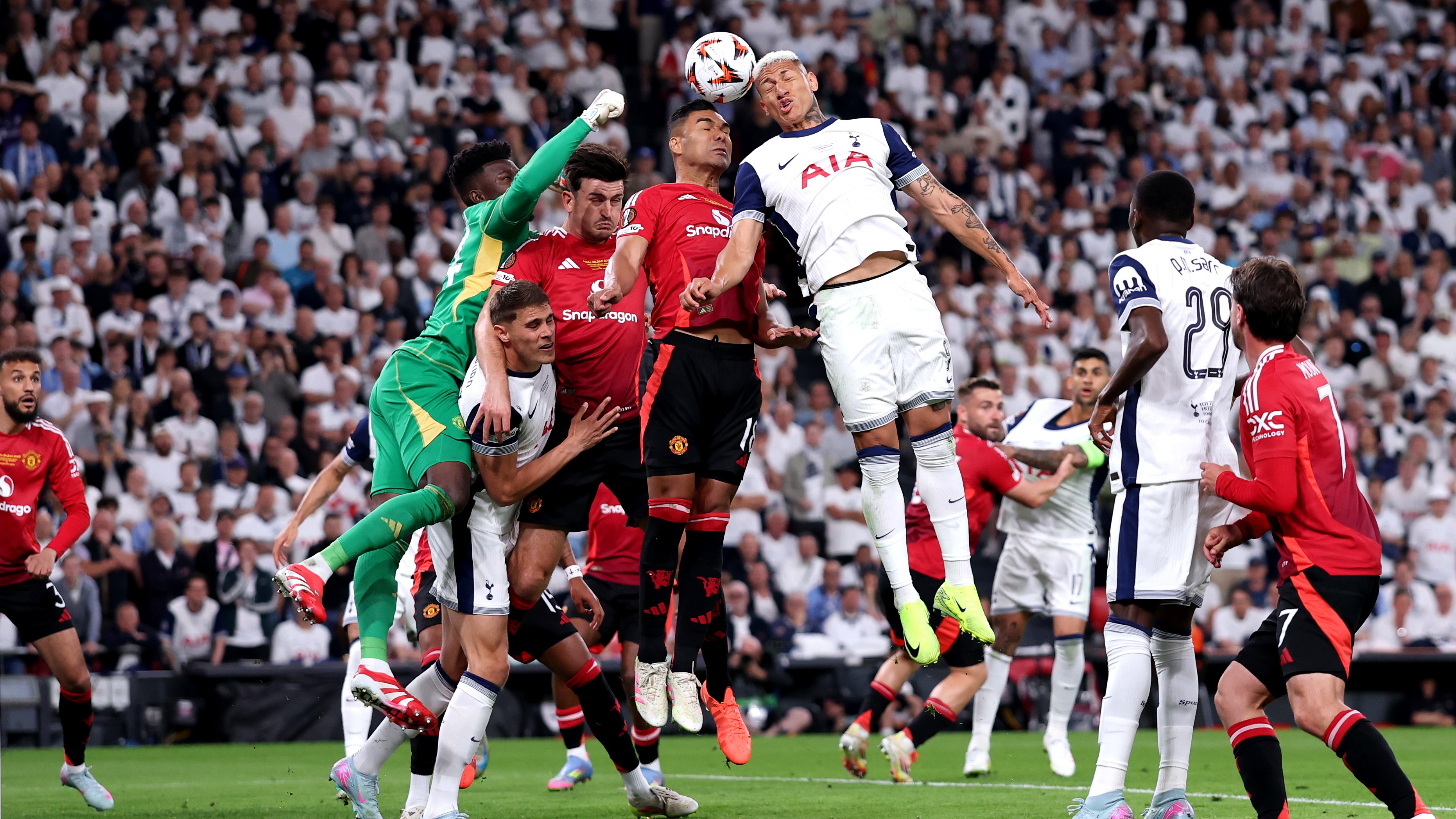 Richarlison battles to win the ball against Onana and Casemiro.