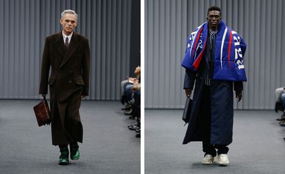 A separate front on view of two men walking down the catwalk holding a bag the left in a coat and the right draped in a Balenciaga scarf