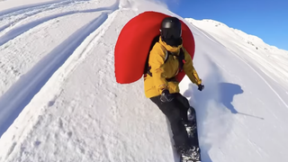 Thomas Feuerstein deploys avalanche airbag while snowboarding