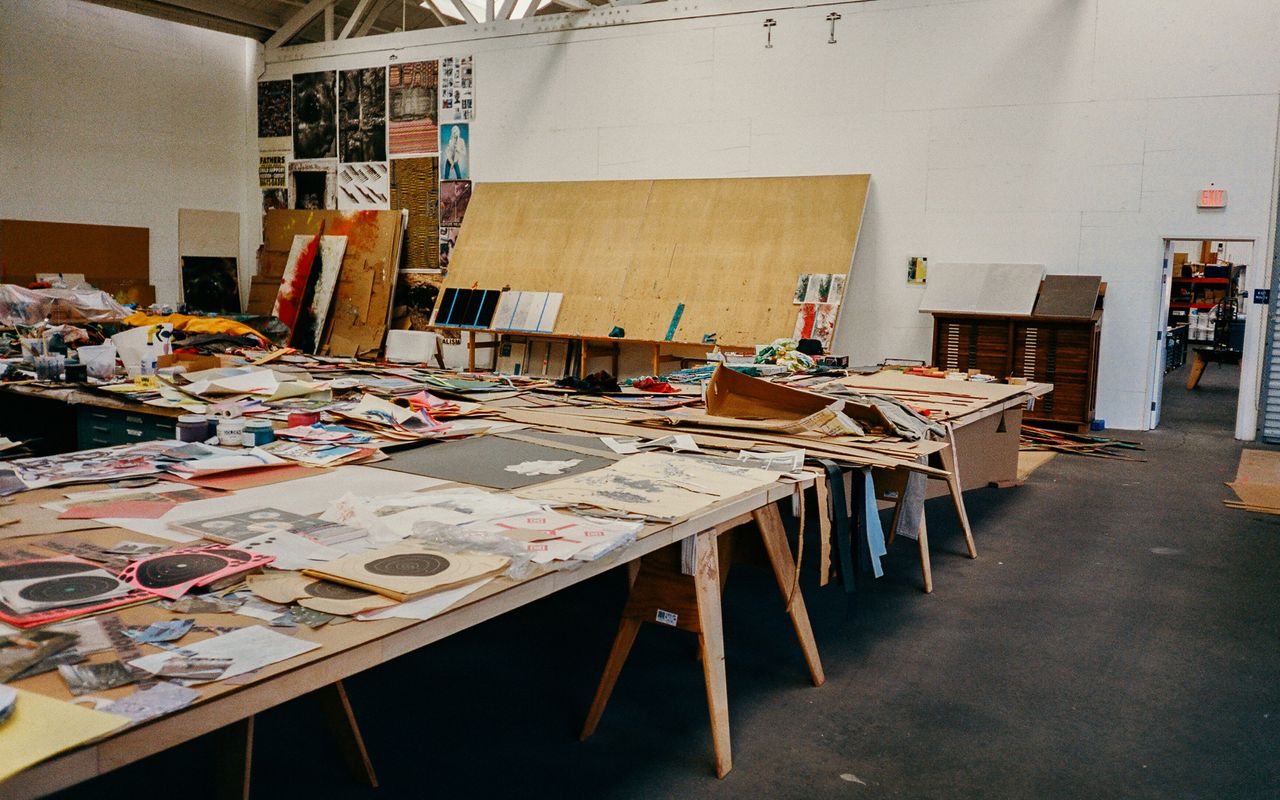 interior view of art studio of Sterling Ruby with artwork on tables