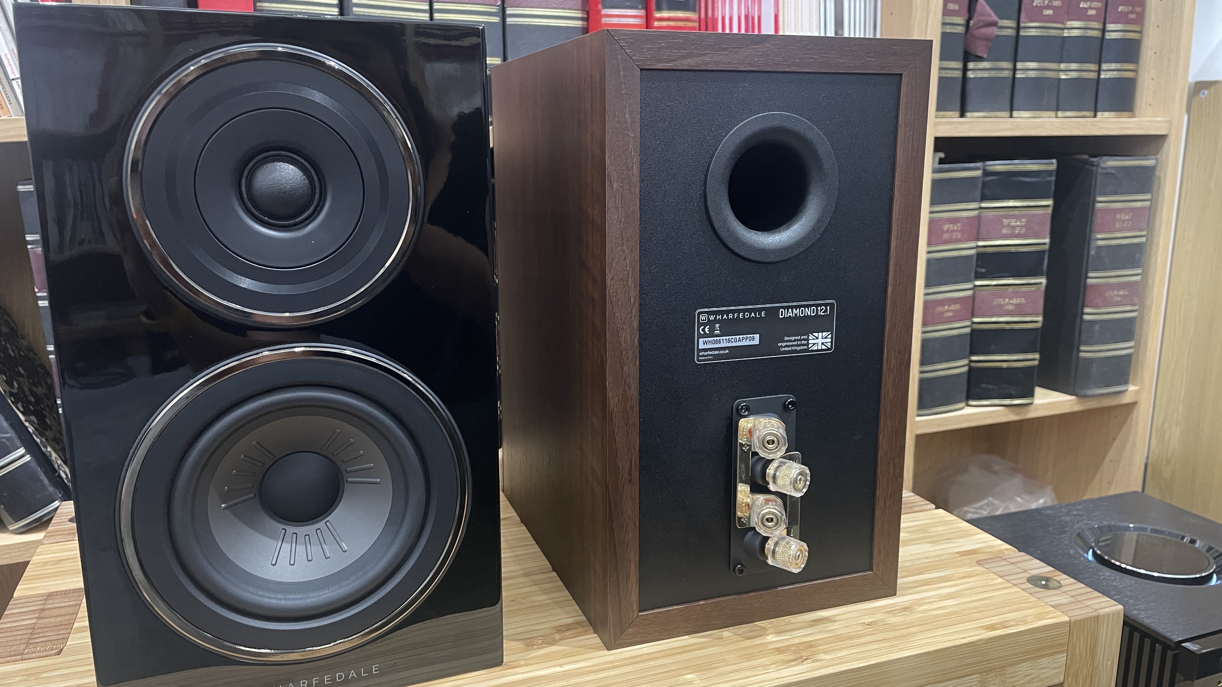 Wharfedale Diamond 12.1 stereo speakers in walnut veneer finish on a wooden rack