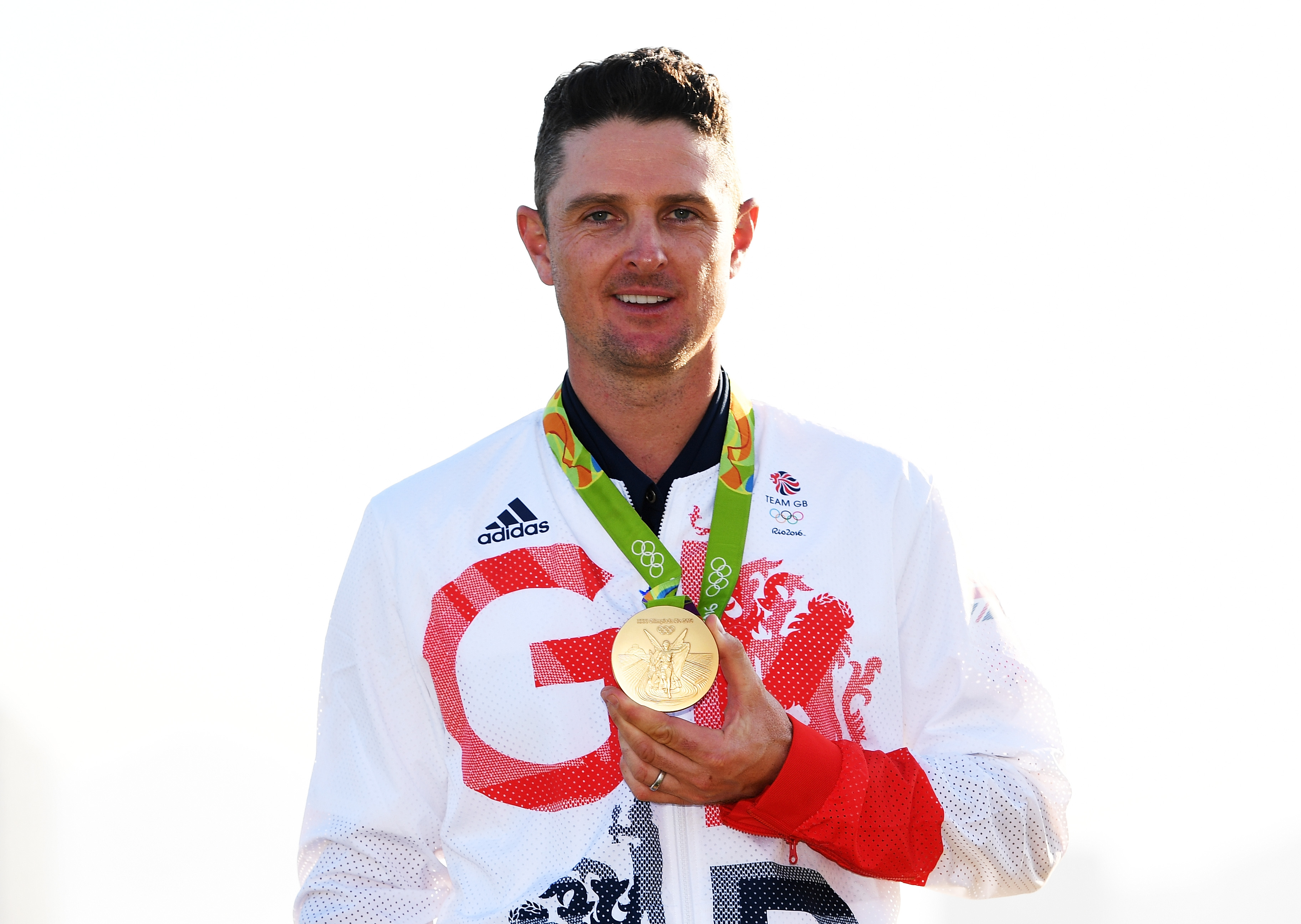 Justin Rose poses with a gold medal