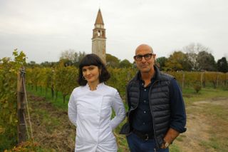 Stanley Tucci stands next to chef Chiara Pavan at Ristorante Venissa in Venice