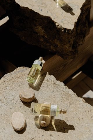 Glass bottles of perfume on a beach