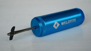Weldtite Tubeless Repair Capsule tool with a repair string