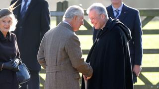 King Charles laughing as he is greeted by The Reverend Canon Dr Paul Williams at a New Year's Day church service