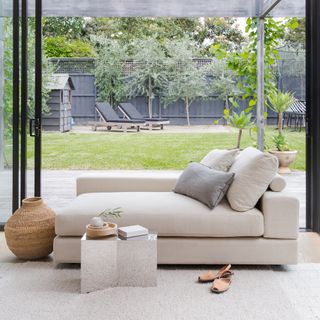 guest room daybed ideas, neutral daybed in front of window, view of garden, neutral scheme, cream rug