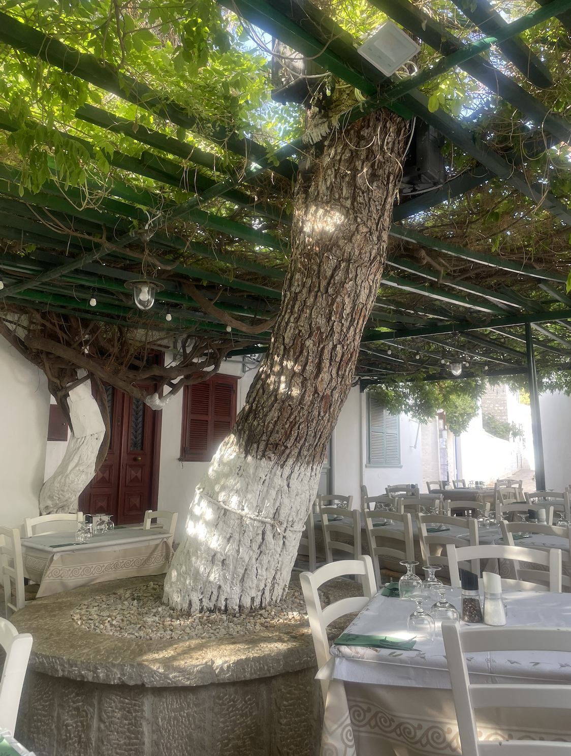 An outside restaurant with white seating