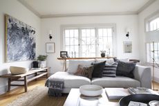 a living room with a grey sofa