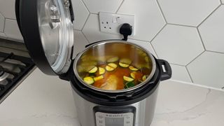 The Instant Pot Duo Plus being used to make chicken curry