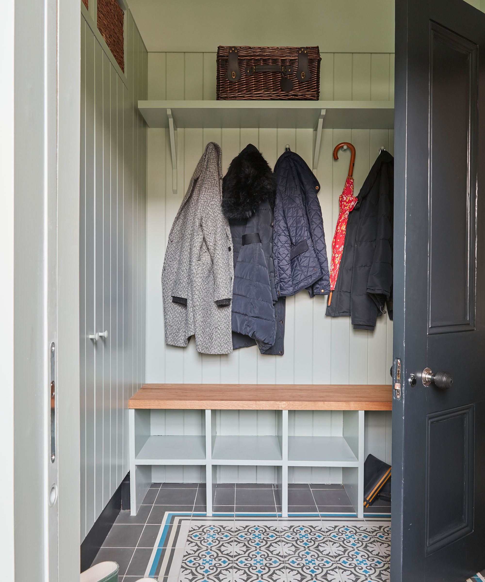 small boot room with coat hanging and storage cubes