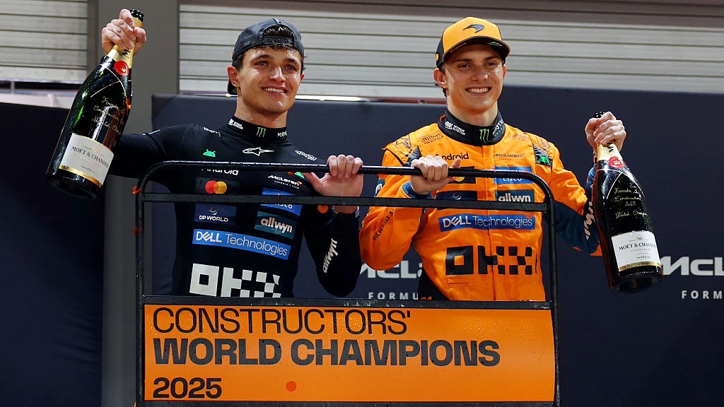 Oscar Piastri and Lando Norris celebrate McLaren winning the Formula 1 constructors' championship after the Singapore Grand Prix