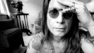 Ozzy Osbourne in black and white looking at the camera