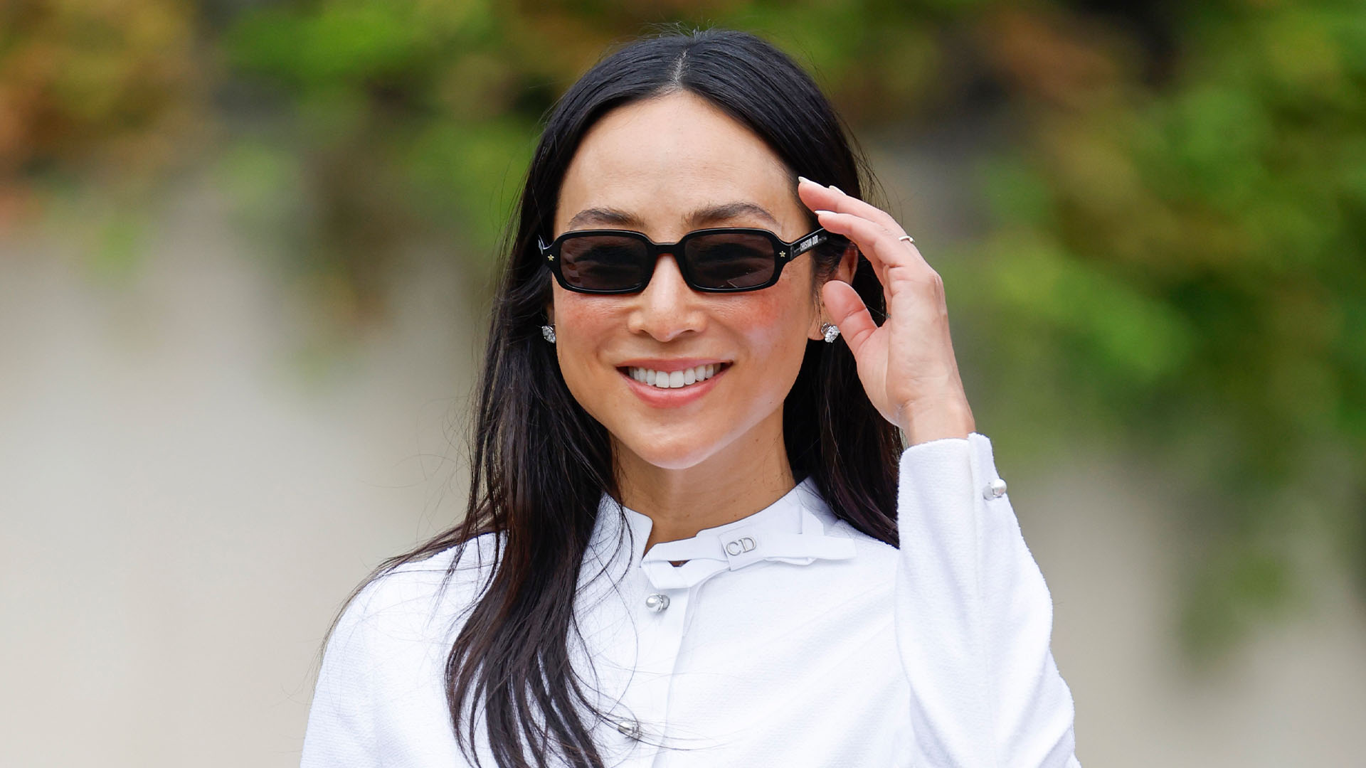 Greta Lee wearing a white set