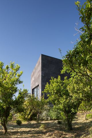 L House dark monolithic exterior block