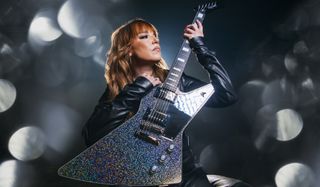 Lzzy Hale holds her new signature Epiphone Explorer Custom