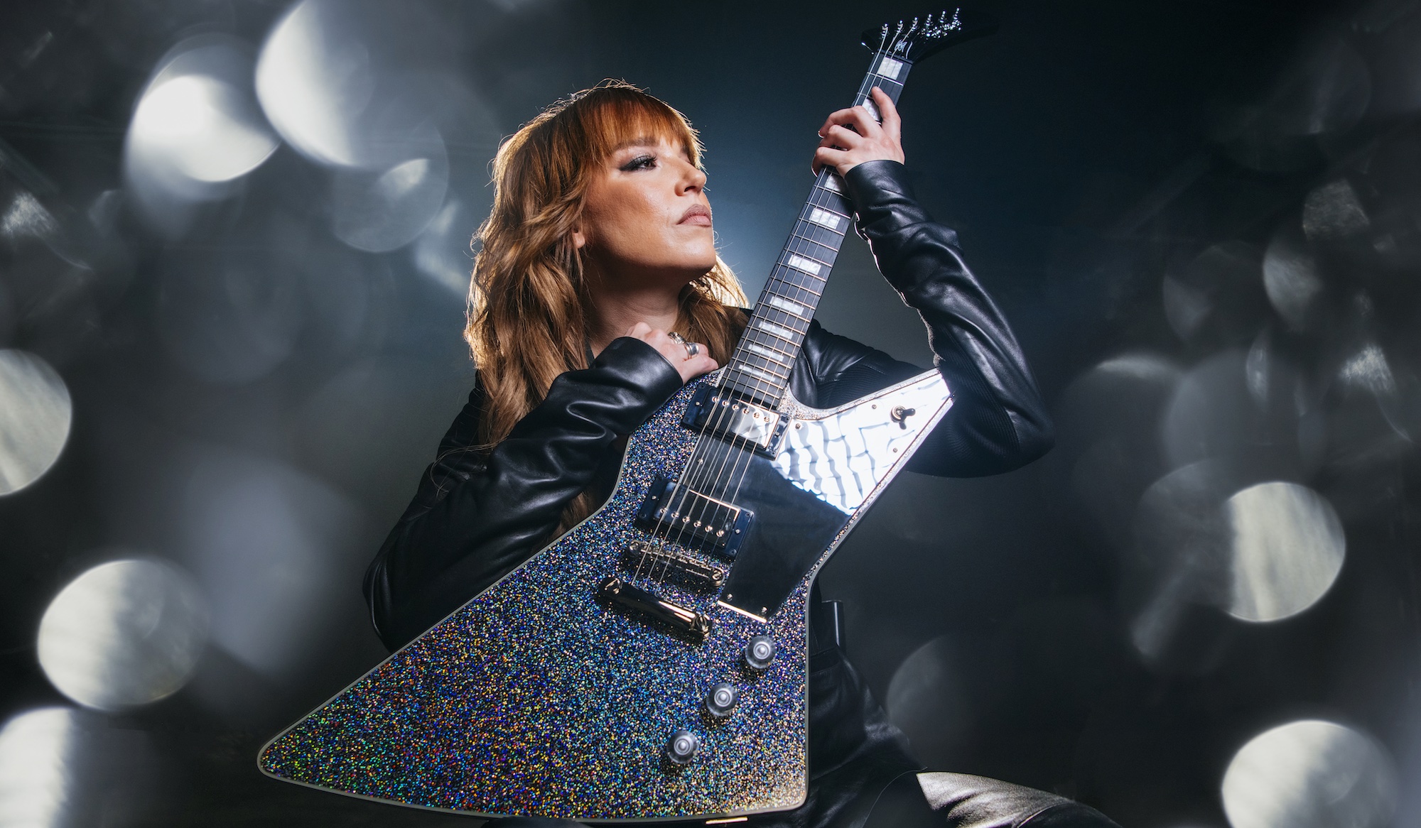 Lzzy Hale holds her new signature Epiphone Explorer Custom