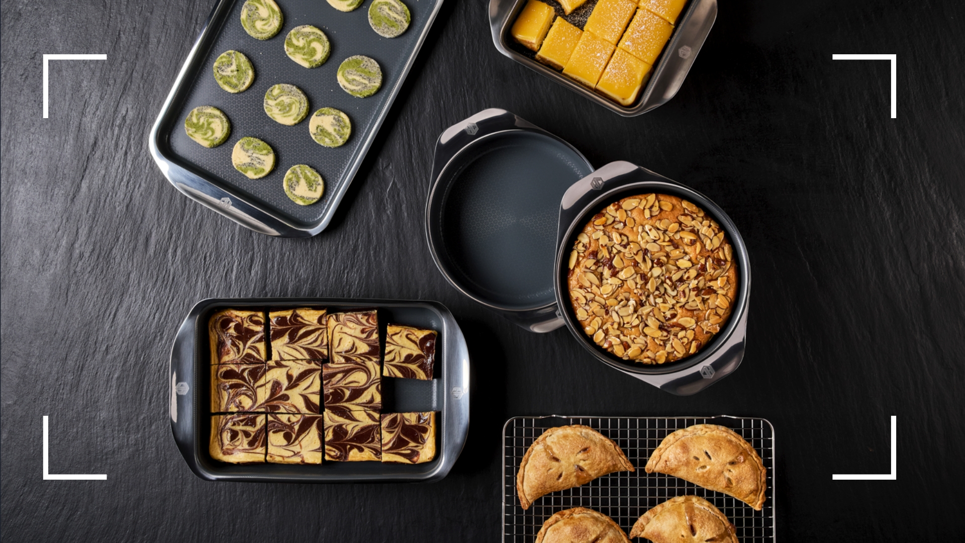 HexClad Hybrid Bakeware being shown with bakes inside, matcha cookies, pies, cake, and lemon bars