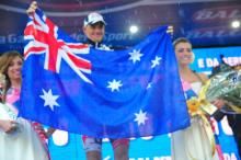 Adam Hansen holds up the Australian flag