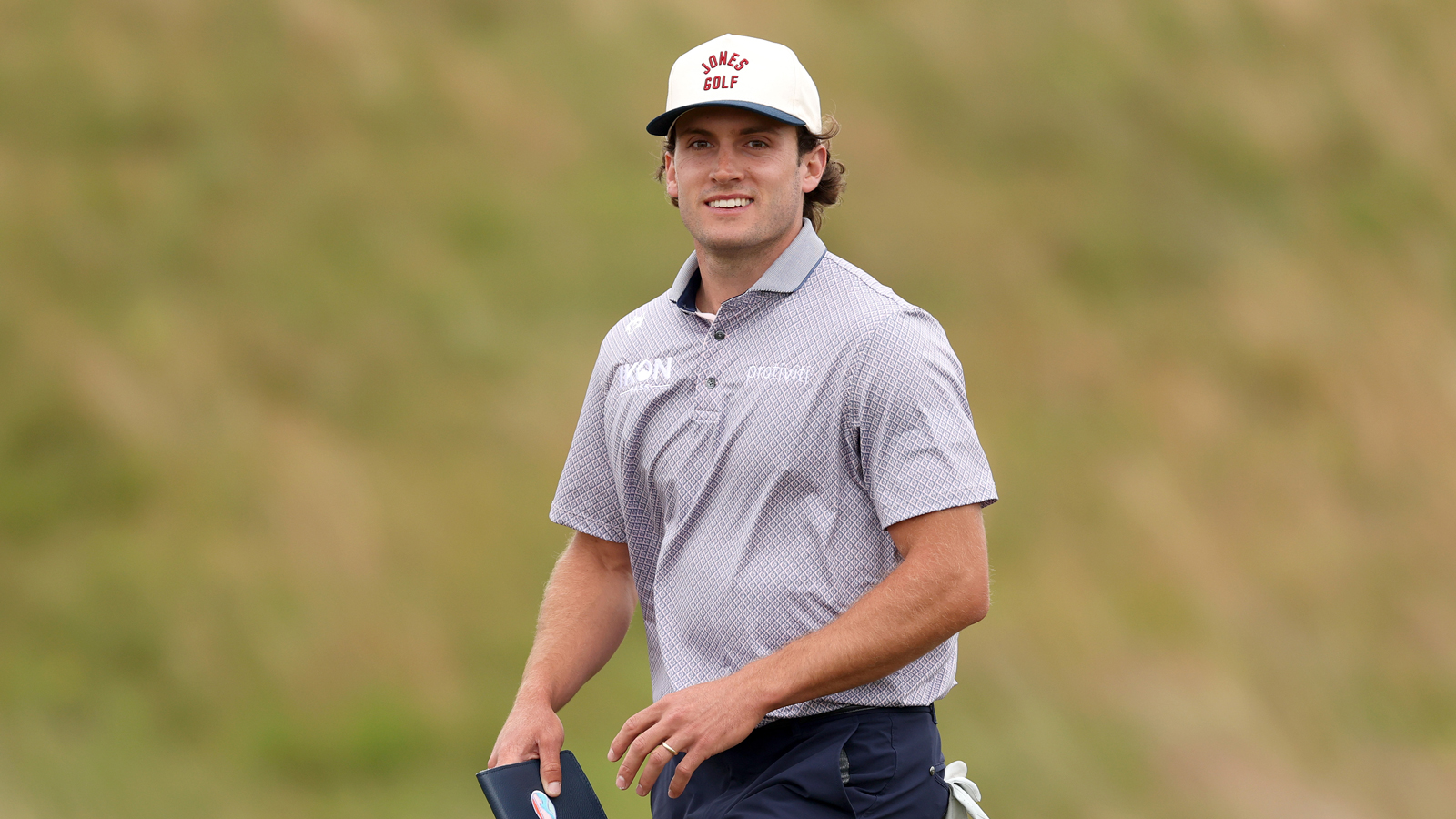 James Nicholas walks down the fairway
