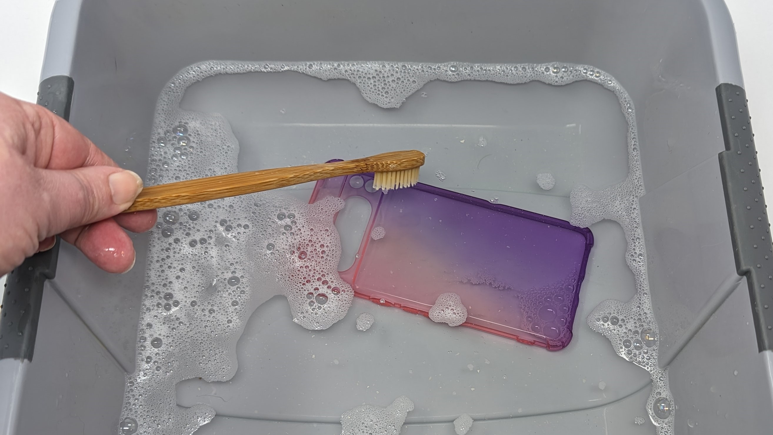 Screenshot showing how to clean a clear phone case - use soft bristled brush