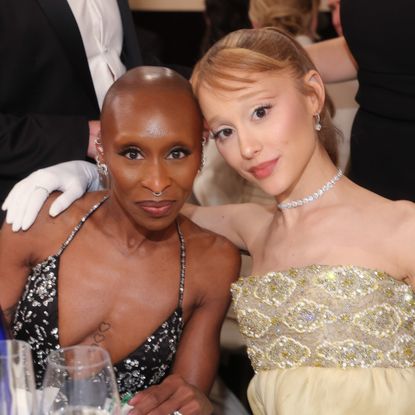 a photo of two women sitting next to each other at a table at an awards show