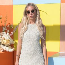 Alix Earle at Cannes Lions Festival, wearing sparkly white mini dress and sunglasses.