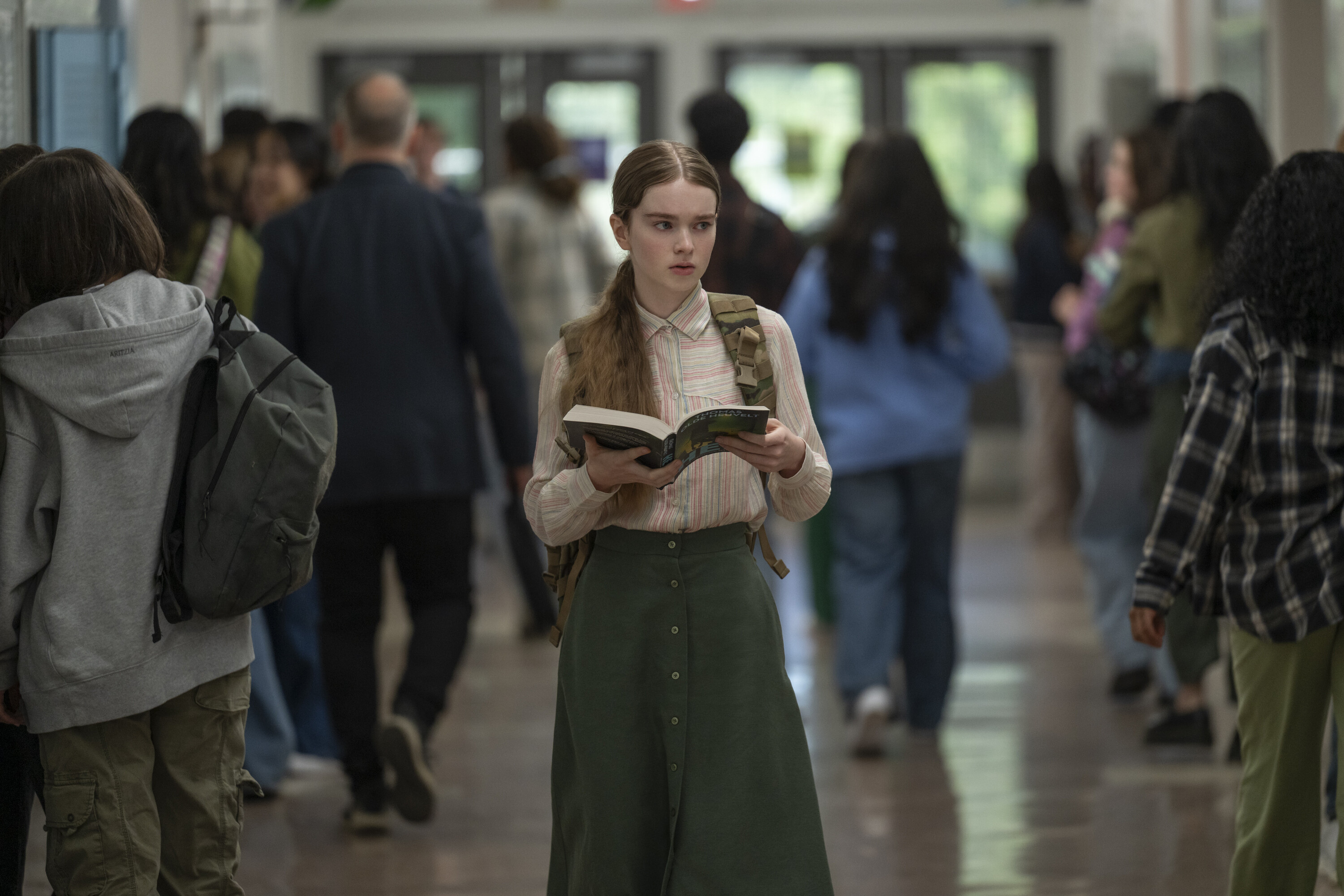 Summer H. Howell as Carrie, walking down a blurred, crowded high-school hallway, in Prime Video#039;s #039;Carrie.#039;