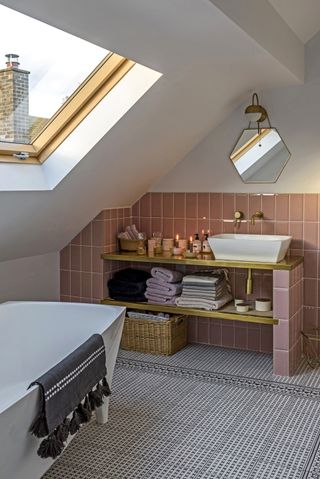 Bathroom with rooflight pink wall tiles black and white patterned floor tiles
