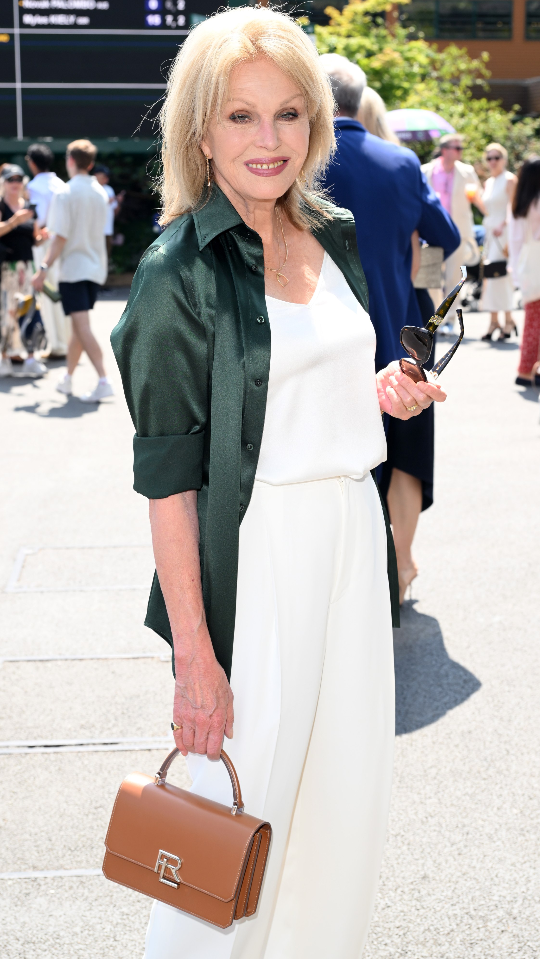 Joanna Lumley, wearing Ralph Lauren, smiles for photos on day 14 of Wimbledon 2025