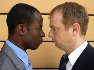 A black businessman and a white businessman face off. 