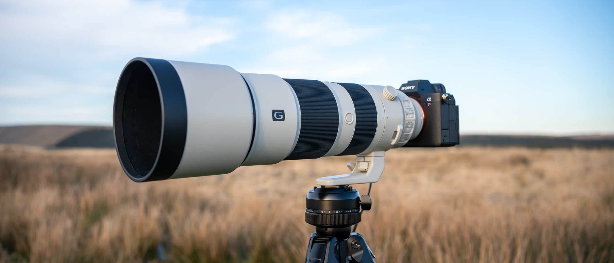 Sony FE 200-600 f/5.6-6.3 G OSS on a tripod in a field