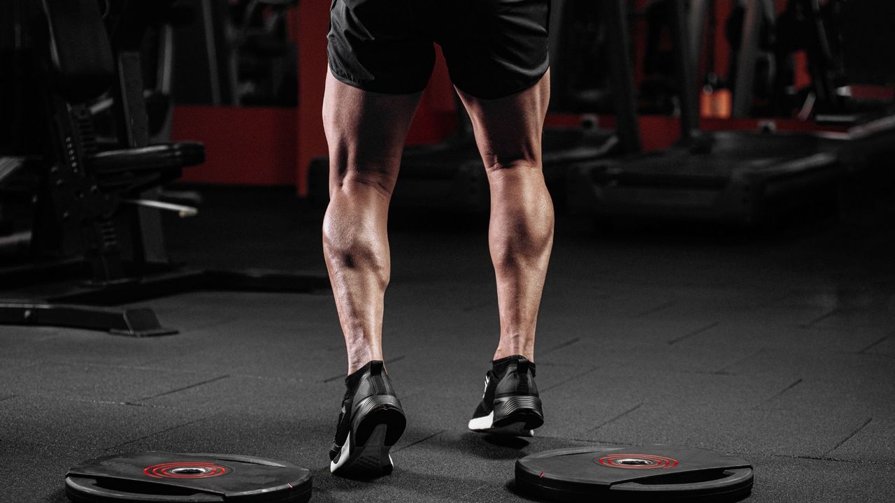 Man standing in the gym with muscular calves