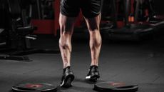 Man standing in the gym with muscular calves