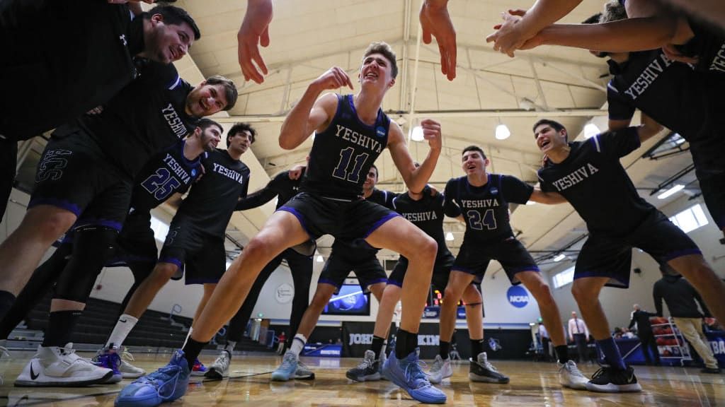 Ryan Turell with his teammates on the basketball court.