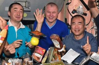 A bottle of Heinz Tomato Ketchup floats above the dining table on the International Space Station in April 2021.