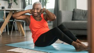 Woman performs Pilates workout at home
