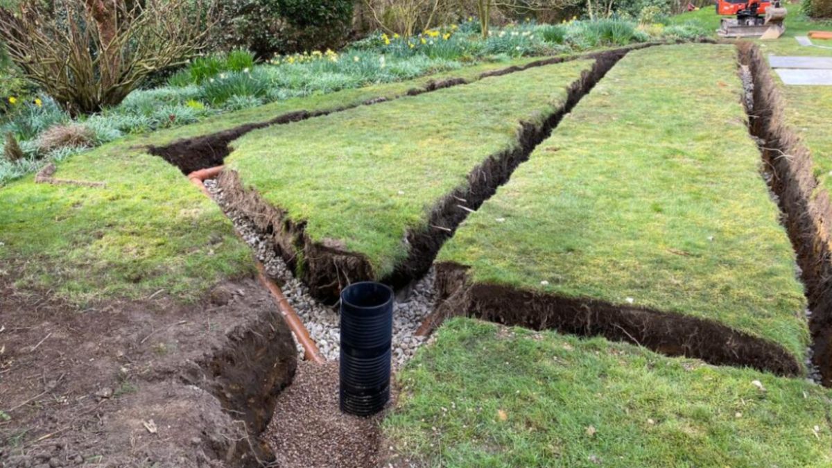 A drainage field with trenching dug out on a lawn