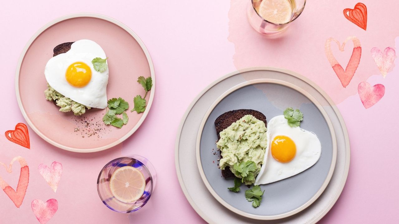 Two plates with heart-shaped brunch food presented as Valentine&#039;s Day date ideas