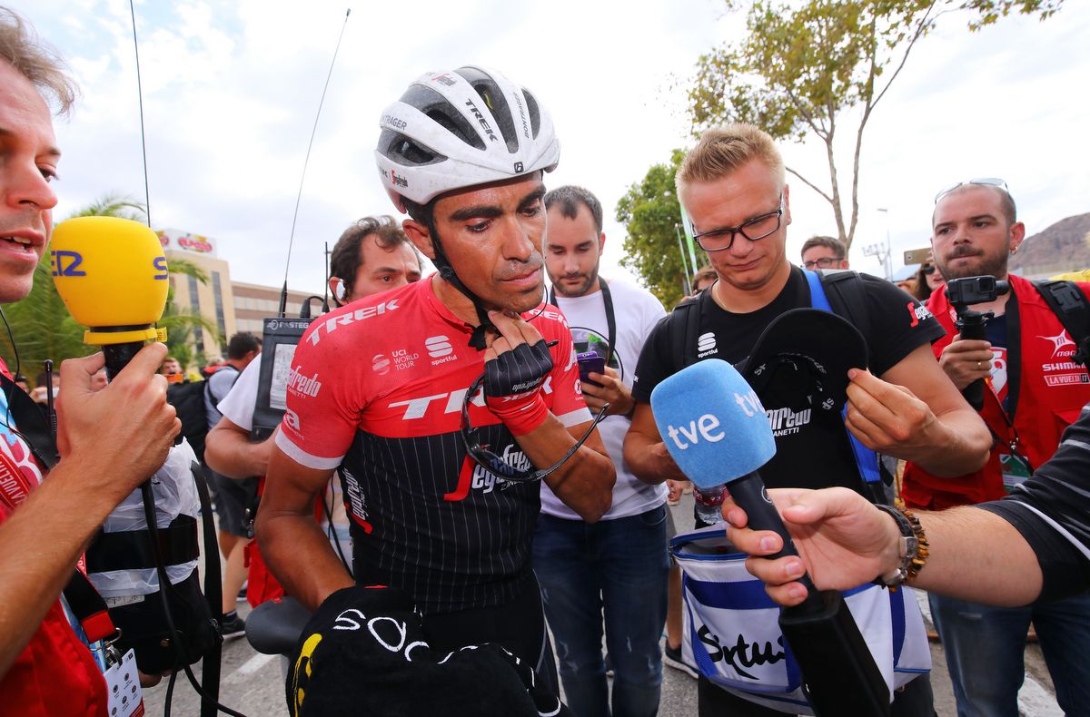 Alberto Contador takes off his helmet before conducting his post-stage interview