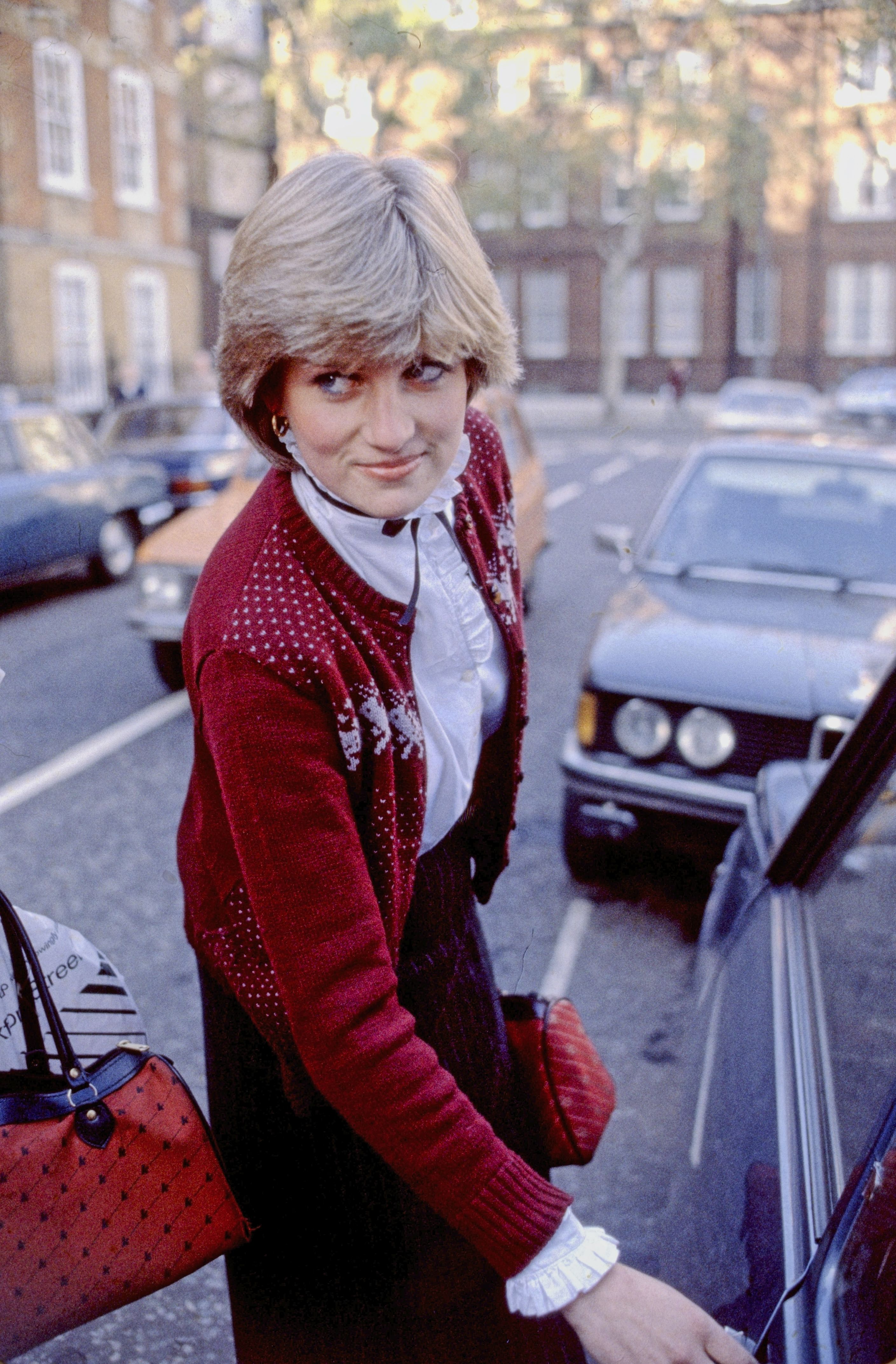 Princess Diana wearing a red sweater and white blouse