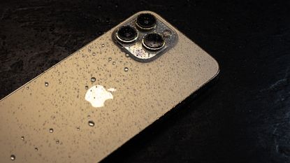 The Apple iPhone 15 Pro, taken by Only_NewPhoto Shutterstock, on black background, with water droplets all over the back of the device