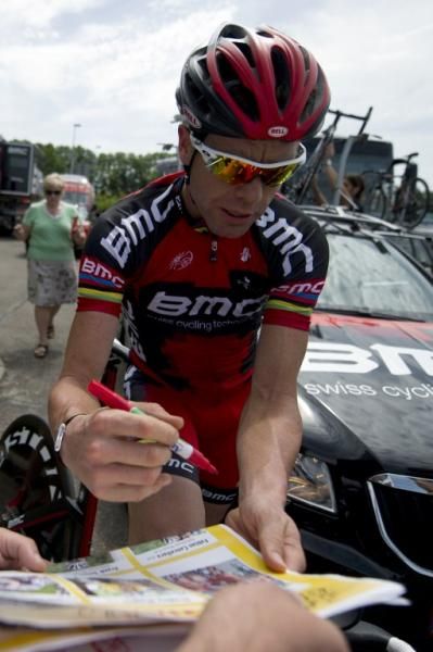 2011 Tour de France champion Cadel Evans (BMC) signs an autograph after a pre-Tour training ride in Liege.