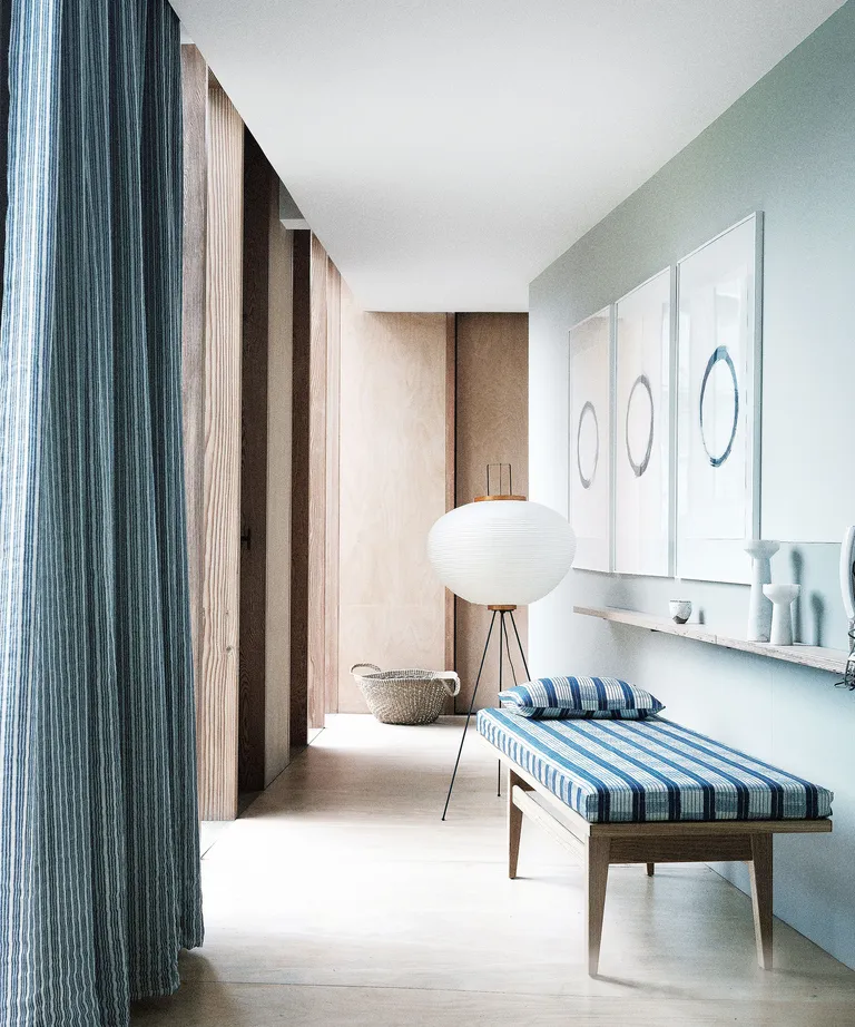 Hallway with wood floor, bench and blue accents