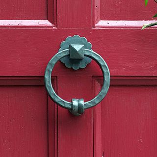 pink door with hand forged ring knocker