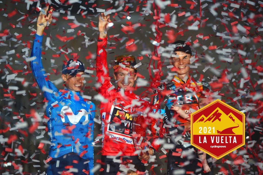 Team Jumbo&#039;s Slovenian rider Primoz Roglic (C) celebrates winning the 2021 La Vuelta cycling tour of Spain flanked by Team Movistar&#039;s Spanish rider Enric Mas (L) and Team Bahrain&#039;s Australian rider Jack Haig after the 21st and final stage, a 33.8 km time-trial from Padron to Santiago de Compostela, on September 5, 2021. (Photo by MIGUEL RIOPA / AFP) (Photo by MIGUEL RIOPA/AFP via Getty Images)