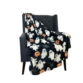 A Halloween blanket on a black chair
