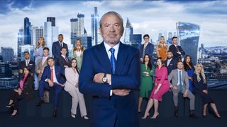 Lord Sugar stands in front of The Apprentice 2023 contestants gathered in two groups.