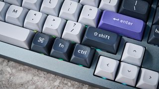 A photo of the Keychron Q1 Pro in gray aluminum with white, black and purple keycaps.